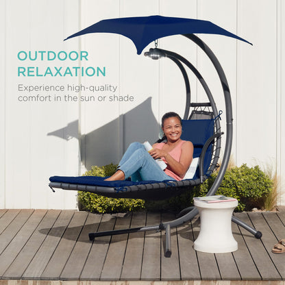 Hanging curved steel chaise lounge swing with canopy and pillow, navy blue.